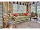 Peaceful sunroom with a light green sofa and access to the outdoors at 1655 Lancashire Dr # 1655, Venice, FL 34293