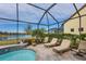 Relaxing screened pool and spa with lake view; comfortable lounge chairs at 18987 Formosa St, Venice, FL 34293