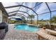 Enjoy this refreshing pool with paver deck, grill, and lake view at 18987 Formosa St, Venice, FL 34293