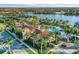 Community clubhouse and pool area with palm trees and lake at 19155 Mangieri St, Venice, FL 34293