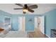 Bright bedroom with light blue walls and access to other rooms at 19155 Mangieri St, Venice, FL 34293