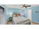 Serene bedroom with light blue walls, a queen-size bed and ceiling fan at 19155 Mangieri St, Venice, FL 34293