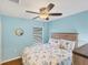 Bright bedroom with a ceiling fan and floral bedding at 19155 Mangieri St, Venice, FL 34293