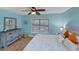 Bedroom with light blue walls, a king-size bed, dresser and ceiling fan at 19155 Mangieri St, Venice, FL 34293