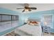 King-size bed, light blue walls, and ceiling fan in this tranquil bedroom at 19155 Mangieri St, Venice, FL 34293
