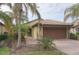 House exterior with a two-car garage and palm trees at 19155 Mangieri St, Venice, FL 34293