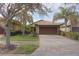 House exterior featuring a two-car garage and landscaped yard at 19155 Mangieri St, Venice, FL 34293