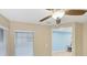 Bright interior room with white blinds, ceiling fan, and view into adjacent room at 19155 Mangieri St, Venice, FL 34293