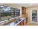 Kitchen with double sink, granite counters, and backyard view at 19155 Mangieri St, Venice, FL 34293