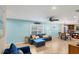 Living room with sectional sofa, light blue walls, and dining area at 19155 Mangieri St, Venice, FL 34293