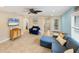 Living room with sectional sofa, stylish decor, and ceiling fan at 19155 Mangieri St, Venice, FL 34293