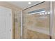 Walk-in shower with tiled walls and a window for natural light at 19155 Mangieri St, Venice, FL 34293