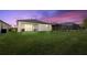 Spacious backyard with screened patio and lush lawn at 1932 W Isles Rd, Port Charlotte, FL 33953