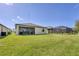 Large backyard with grassy lawn and screened patio at 1932 W Isles Rd, Port Charlotte, FL 33953
