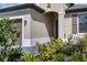 Front entrance with a covered walkway and lush landscaping at 1932 W Isles Rd, Port Charlotte, FL 33953