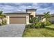 One-story house with a two-car garage and well-maintained lawn at 1932 W Isles Rd, Port Charlotte, FL 33953