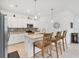 Island kitchen with granite countertops and white cabinets at 1932 W Isles Rd, Port Charlotte, FL 33953