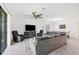 Open living room with sectional sofa and views to dining area at 1932 W Isles Rd, Port Charlotte, FL 33953