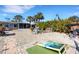 Large backyard with cornhole, patio furniture, and landscaping at 1985 Fairview Dr, Englewood, FL 34223