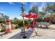 Relaxing backyard with firepit, benches, and whimsical decor at 1985 Fairview Dr, Englewood, FL 34223