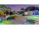 Night view of the backyard with games and lights at 1985 Fairview Dr, Englewood, FL 34223