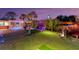 Landscaped backyard with fun games at night at 1985 Fairview Dr, Englewood, FL 34223
