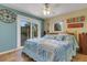 Main bedroom with a king-size bed and access to a patio at 1985 Fairview Dr, Englewood, FL 34223