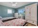 Bedroom with twin beds, dresser, and white armoire at 1985 Fairview Dr, Englewood, FL 34223