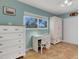 Bedroom with white dresser, desk and chair at 1985 Fairview Dr, Englewood, FL 34223