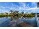 Calm canal view with reflections of the sky and trees at 1985 Fairview Dr, Englewood, FL 34223