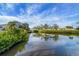 Scenic view of a peaceful canal with lush vegetation at 1985 Fairview Dr, Englewood, FL 34223