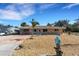 Single story home with a landscaped yard, brick paver driveway and boat parking at 1985 Fairview Dr, Englewood, FL 34223