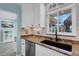 Clean kitchen with granite countertops and modern sink and faucet at 1985 Fairview Dr, Englewood, FL 34223
