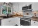 Bright kitchen with granite countertops and stainless steel appliances at 1985 Fairview Dr, Englewood, FL 34223