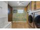 Laundry room with tropical mural and new washer/dryer at 1985 Fairview Dr, Englewood, FL 34223
