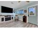 Living room with fireplace, TV, and rocking chair at 1985 Fairview Dr, Englewood, FL 34223