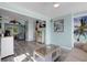 Open living space with gray floors and a view into the sunroom at 1985 Fairview Dr, Englewood, FL 34223