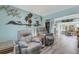 Living room with gray recliners and coastal wall art at 1985 Fairview Dr, Englewood, FL 34223