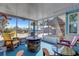 Screened patio features colorful chairs, a fire pit, and backyard view at 1985 Fairview Dr, Englewood, FL 34223