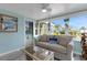 Relaxing sunroom with sofa, coffee table, and tropical decor at 1985 Fairview Dr, Englewood, FL 34223