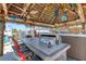 Covered patio with tiki bar, hot tub, and grill at 1985 Fairview Dr, Englewood, FL 34223