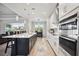 Modern kitchen with white cabinetry, large island, and stainless steel appliances at 19854 Bridgetown Loop, Venice, FL 34293