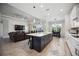 Open concept kitchen with island, looking into living room at 19854 Bridgetown Loop, Venice, FL 34293