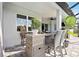 Cozy outdoor seating area with wicker chairs and small table at 19854 Bridgetown Loop, Venice, FL 34293