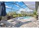 Inviting pool and spa area with lounge chairs under a screened enclosure at 19854 Bridgetown Loop, Venice, FL 34293