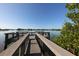 Tranquil boardwalk extending over calm waters with lush greenery at 199 Palm Air Dr, Osprey, FL 34229