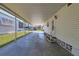 Covered carport with concrete slab and access to the front door of the mobile home at 199 Palm Air Dr, Osprey, FL 34229