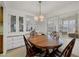 Bright dining room with built-in hutch and oval wood table at 199 Palm Air Dr, Osprey, FL 34229