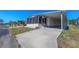 Exterior view of a white mobile home with a carport and screened porch at 199 Palm Air Dr, Osprey, FL 34229