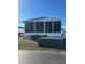 White single-wide manufactured home with screened porch at 199 Palm Air Dr, Osprey, FL 34229